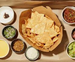 Bar Ama signature dishes Guacamole and Chips, Puffy Tacos, Rolled Serrano & Egg Burrito.